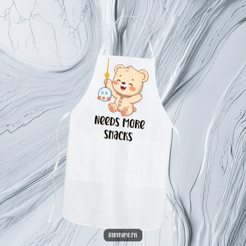 Funny baby bear cub in a onesie, playfully reaching for a mobile while ready for kitchen adventures, depicted on a charming apron.