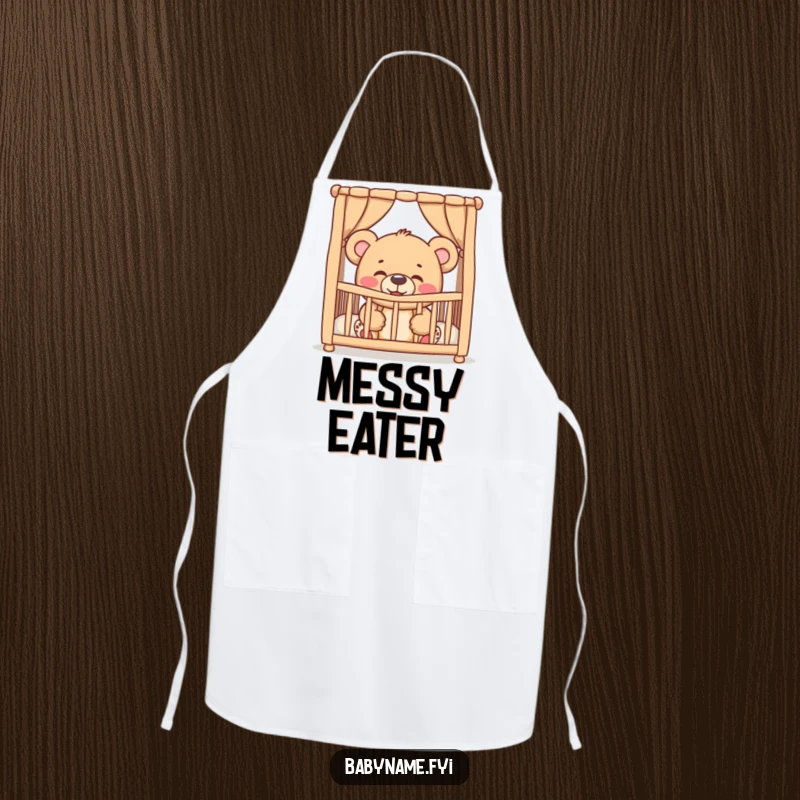 Funny giggling teddy bear peeking from a crib, on a practical apron, bringing humorous baby charm to the kitchen.