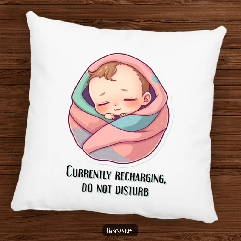 Funny baby pillow showcasing a peaceful infant character curled up and asleep, wrapped in a snug and colorful blanket.