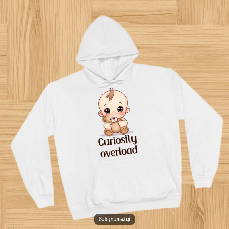 Funny baby with wide curious eyes holding a teddy bear, a cozy and funny hoodie.