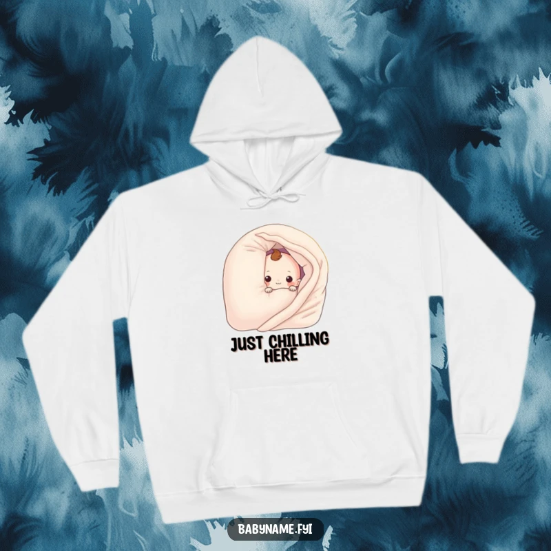 Funny baby blanket character playfully hiding behind a pillow, featured on a warm hoodie. Humorous and cozy apparel.