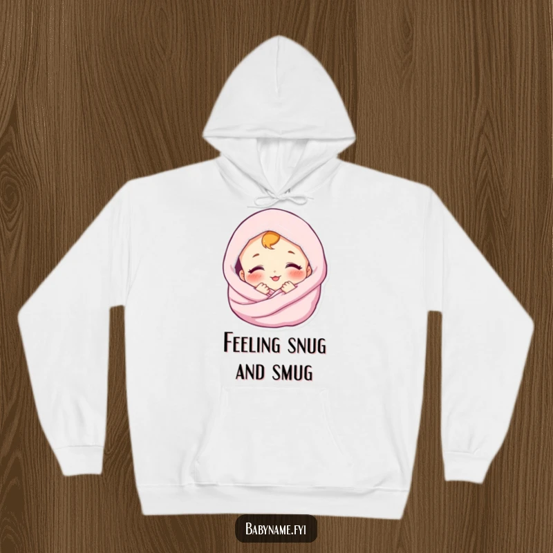 Funny hoodie featuring a contented baby character enveloped in a soft blanket, smiling. Utmost cozy apparel.