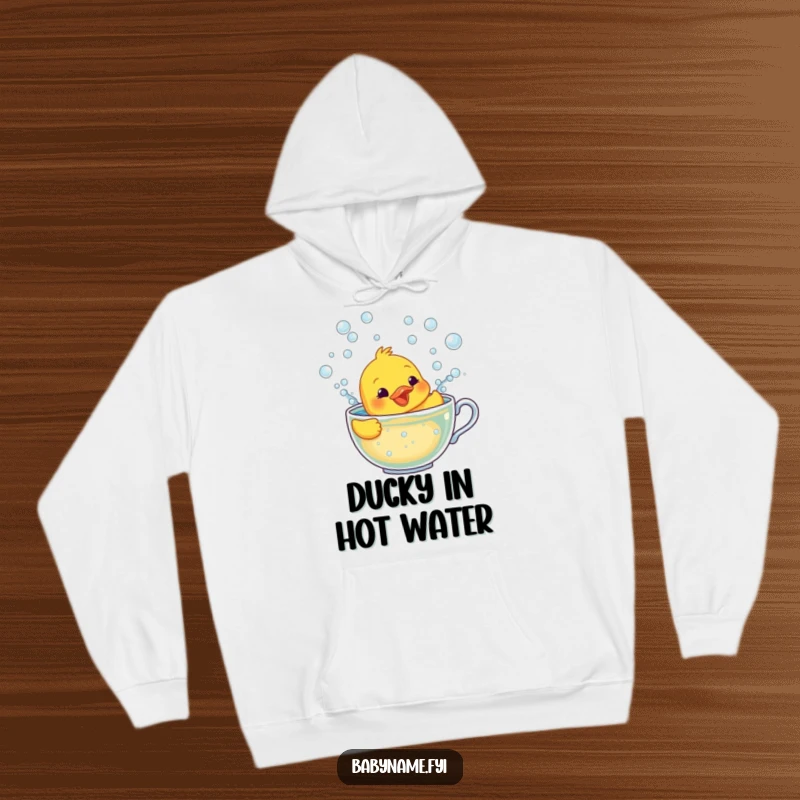 Funny hoodie featuring a smiling rubber ducky character frantically swimming in a teacup overflowing with bubbles, perfect for cozy days.