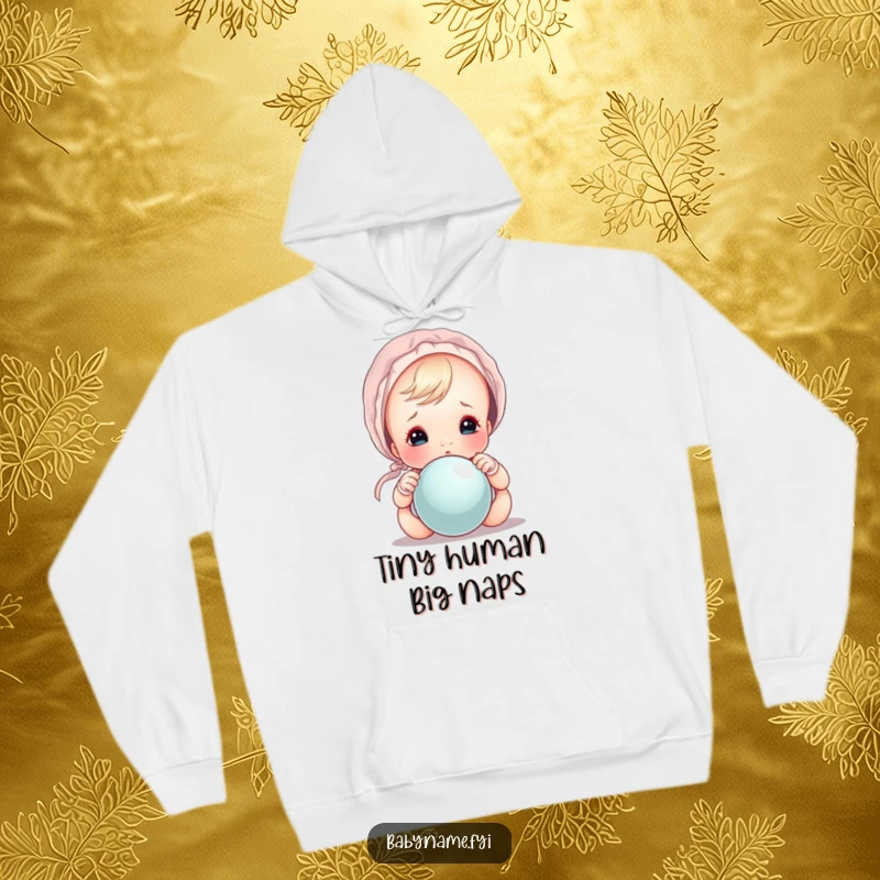 Funny baby in bonnet peeking over rattle, a comfortable and humorous hoodie for all ages.