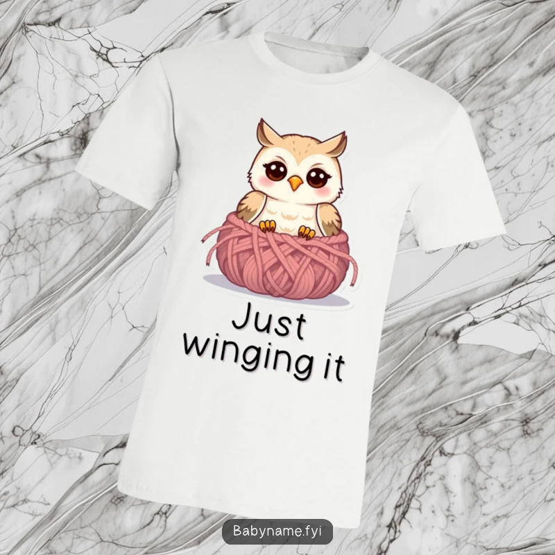 Funny baby owl t-shirt showcasing a cheerful owlet emerging from a cozy knitted nest, full of playful innocence.